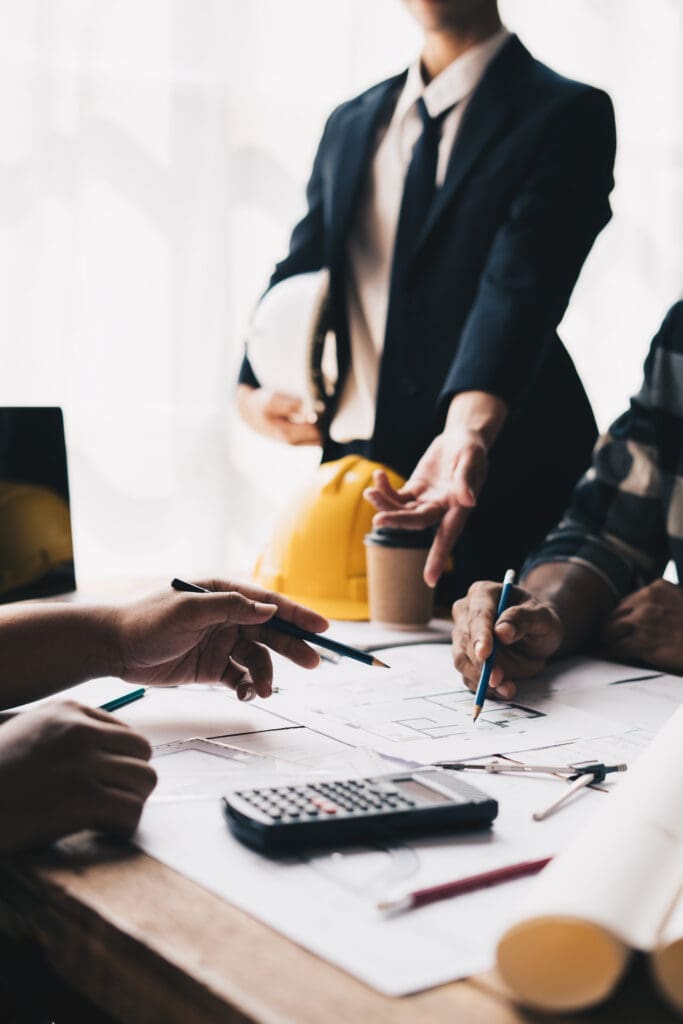 Engineer meeting for architectural project. working with partner and engineering tools on workplace.